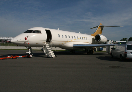 A white airplane with stairs going up the side.