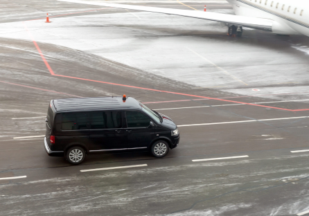 A van driving down the road in the snow.