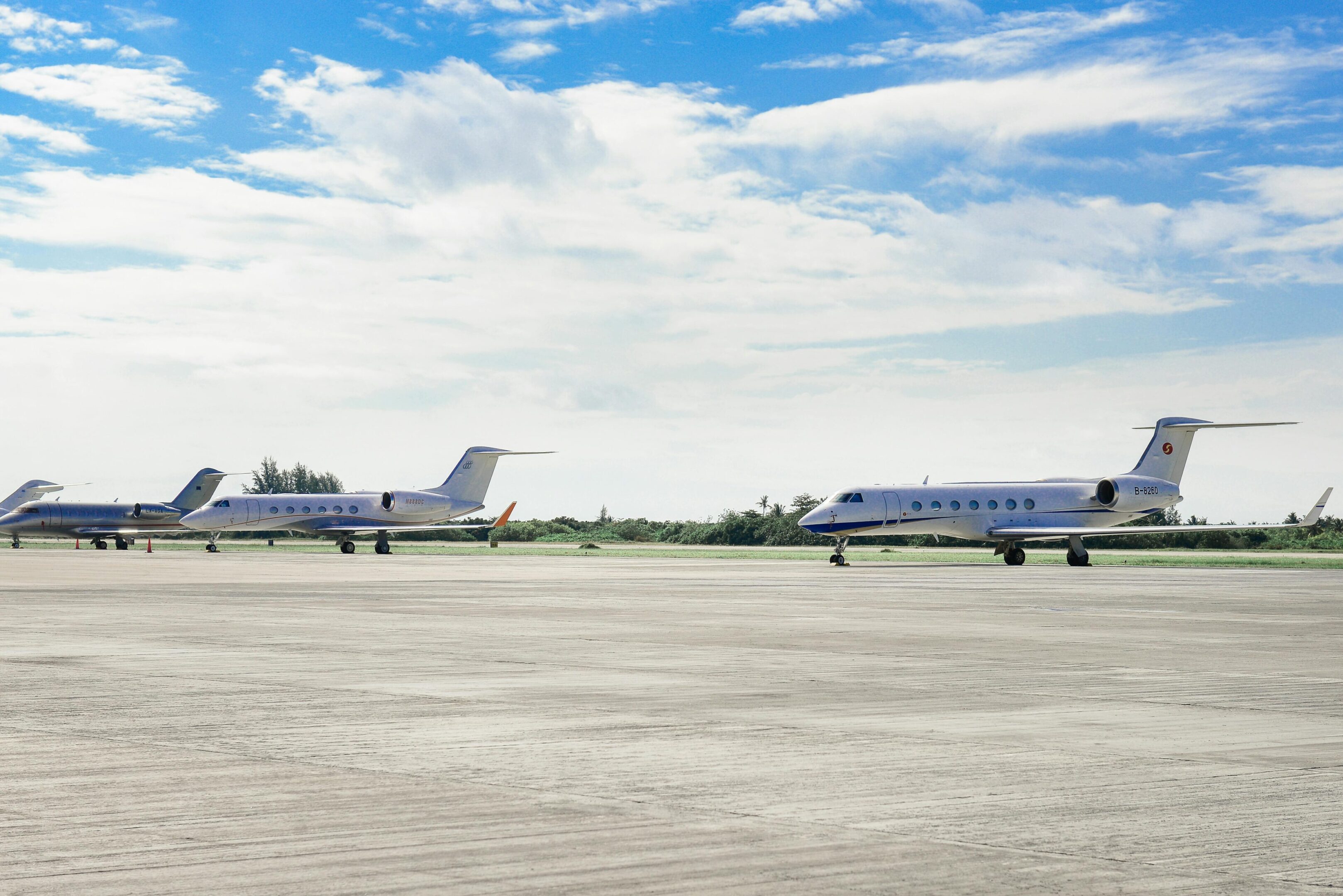 Two airplanes are parked on a runway in the desert.